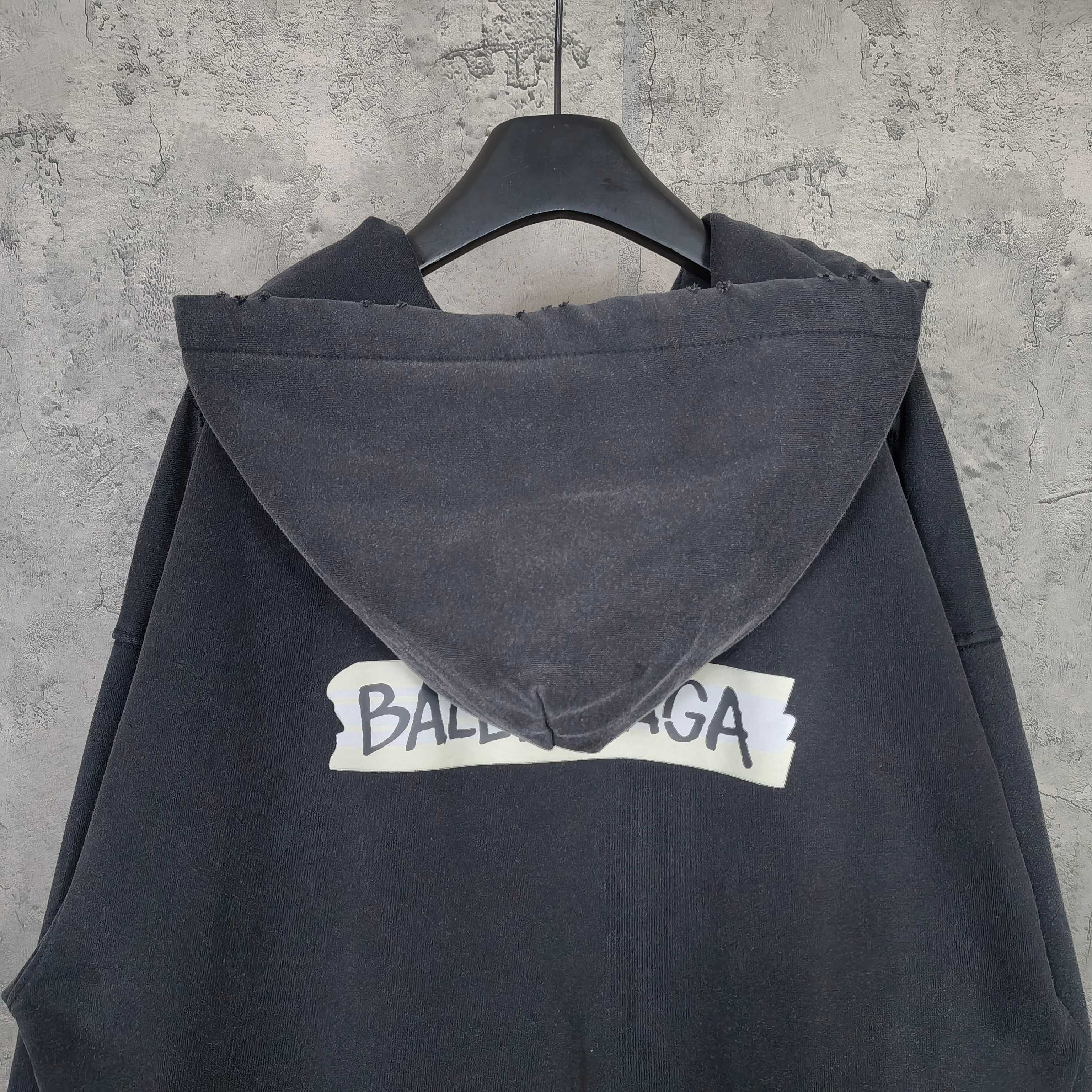 Dark zip-up hoodie jacket with hood and large back logo text