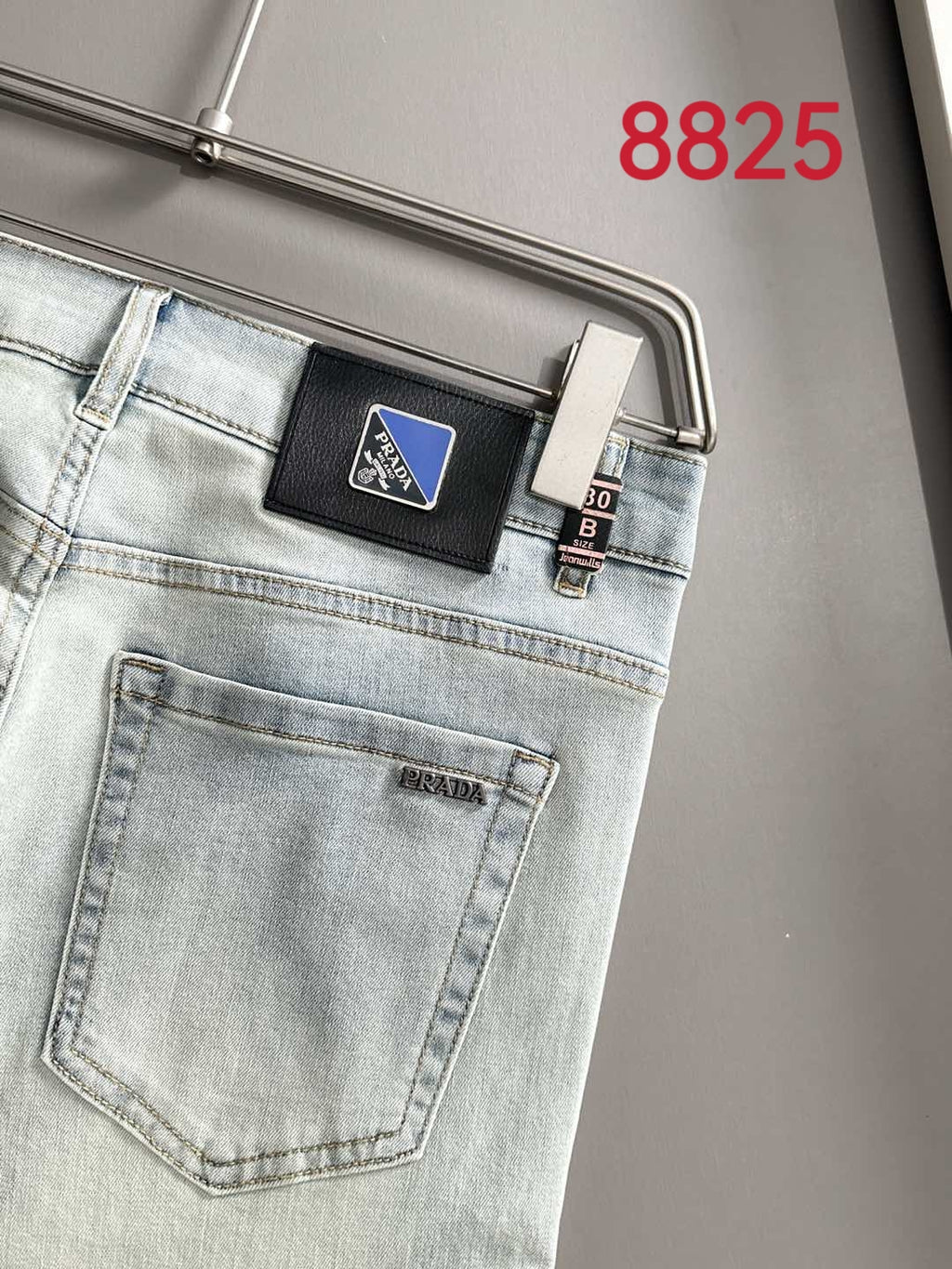 Light-wash denim pants back pocket with PRADA leather patch label