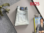 Light-wash denim pants on hanger with belt loops and front pockets