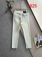 Light-wash denim pants on hanger with belt loops and front pockets
