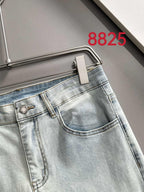 Light-wash denim pants front view with coin pocket and button closure