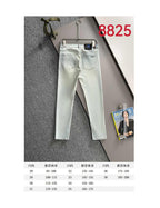 Light-wash denim pants laid out with belt loops and front pockets