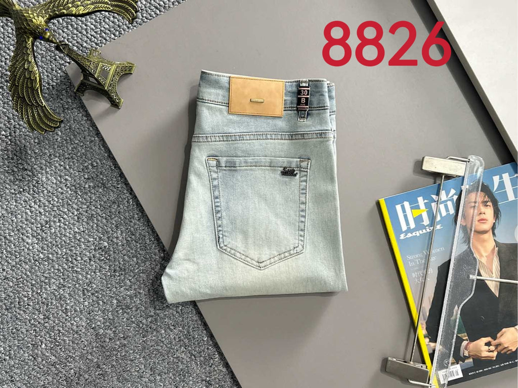 Light wash denim pants, back view with two patch pockets and tan logo patch