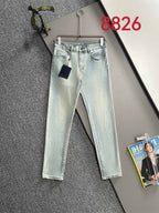 Light wash denim pants with front pockets, belt loops, and attached hanging tag