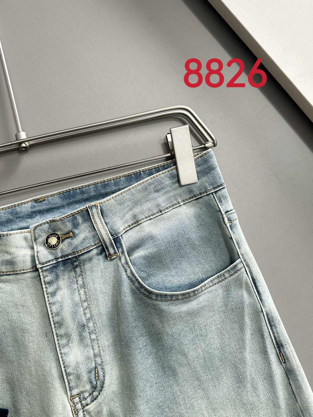 Light wash denim pants front waistband with stitched fly and belt loops