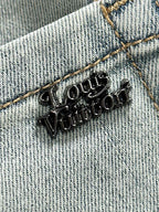 Denim fabric with LV logo metal embroidery and gold-tone stitching detail