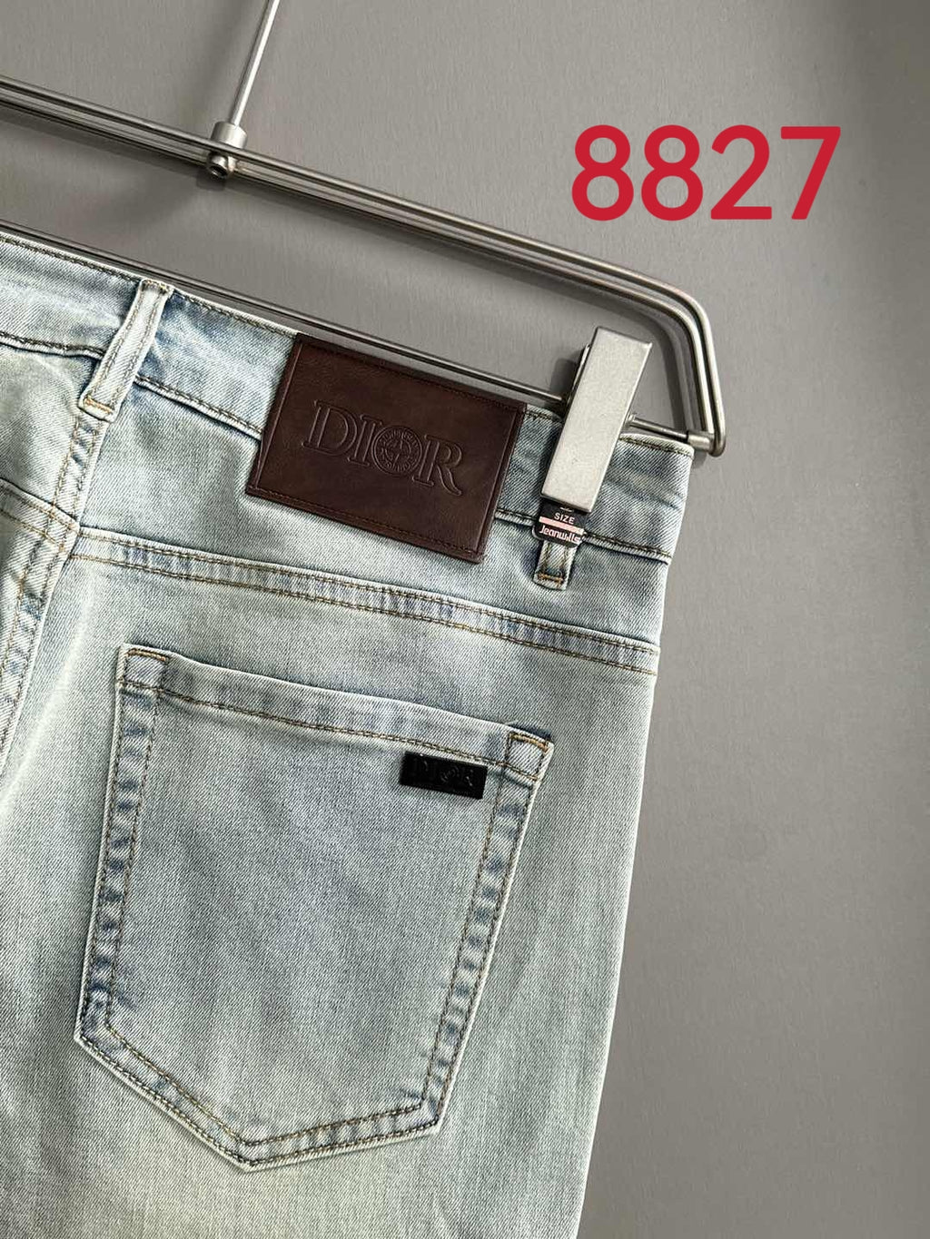 Light blue denim jeans back view with leather-look Dior patch and pocket