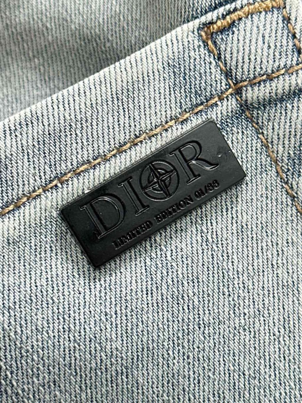 Light blue denim jeans interior brand label patch on stitched seam