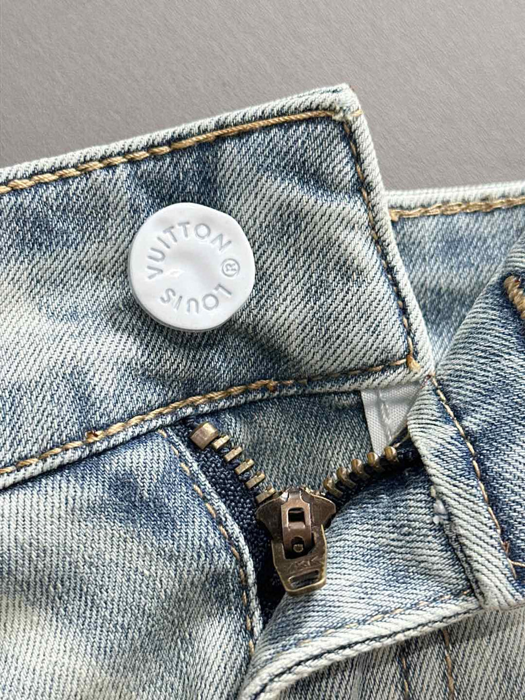 Denim jeans close-up of waistband patch and zipper hardware