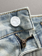 Denim jeans close-up of waistband patch and zipper hardware