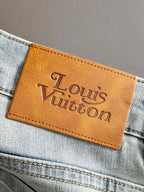 Louis Vuitton logo leather patch on light-wash denim pocket
