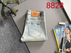 Light-wash denim jeans folded flat with back label patch and back pockets
