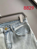 Light-wash denim jeans close-up of front pocket and curved waistband seam