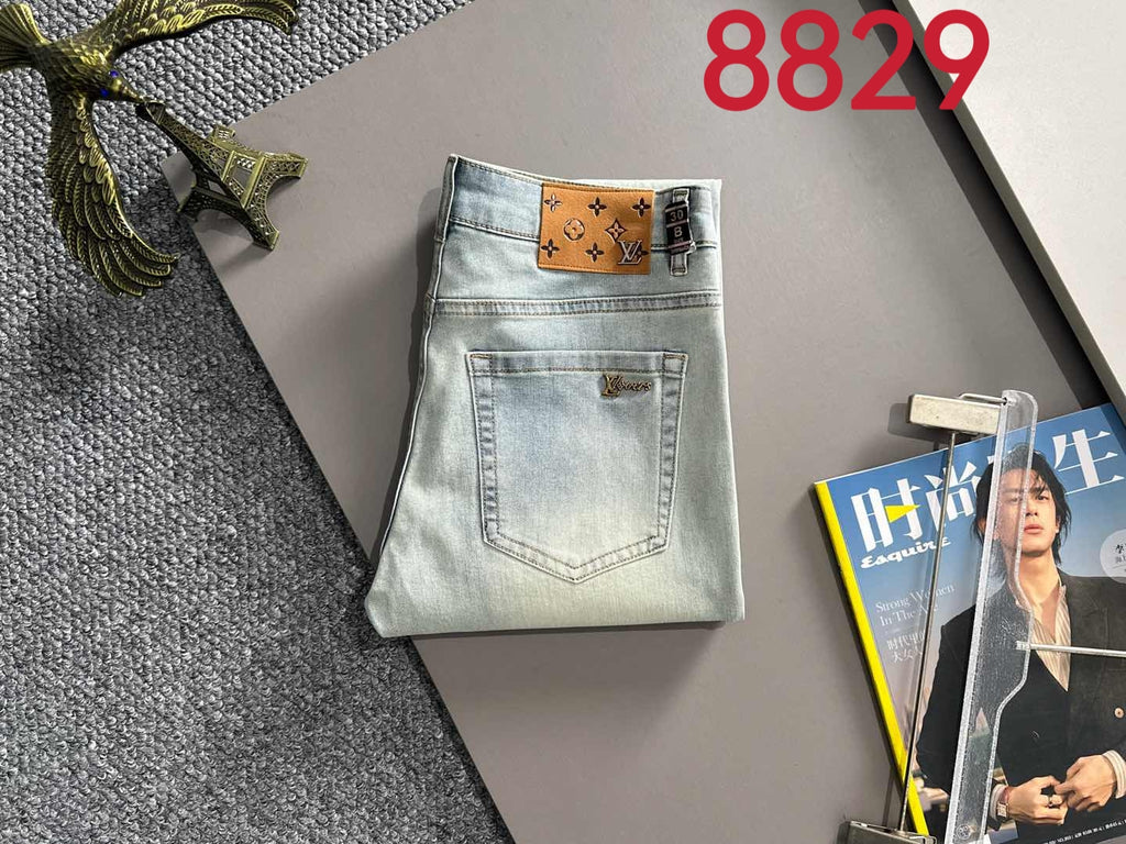 Light-wash denim jeans folded layout with front pockets and waist detail, on display
