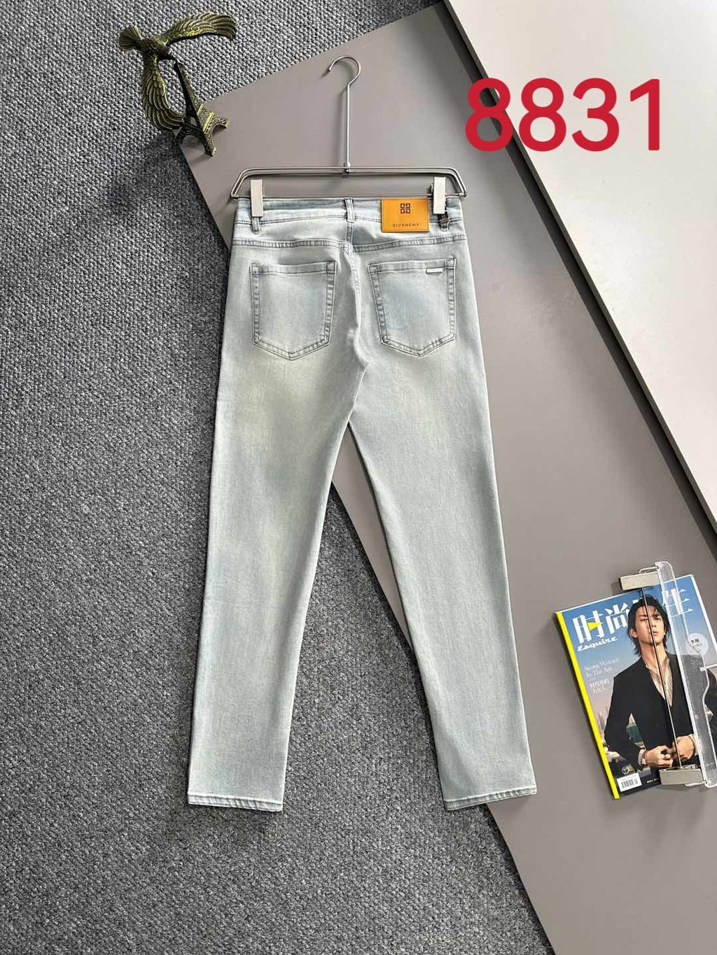 Givenchy light-wash jeans on hanger, front view