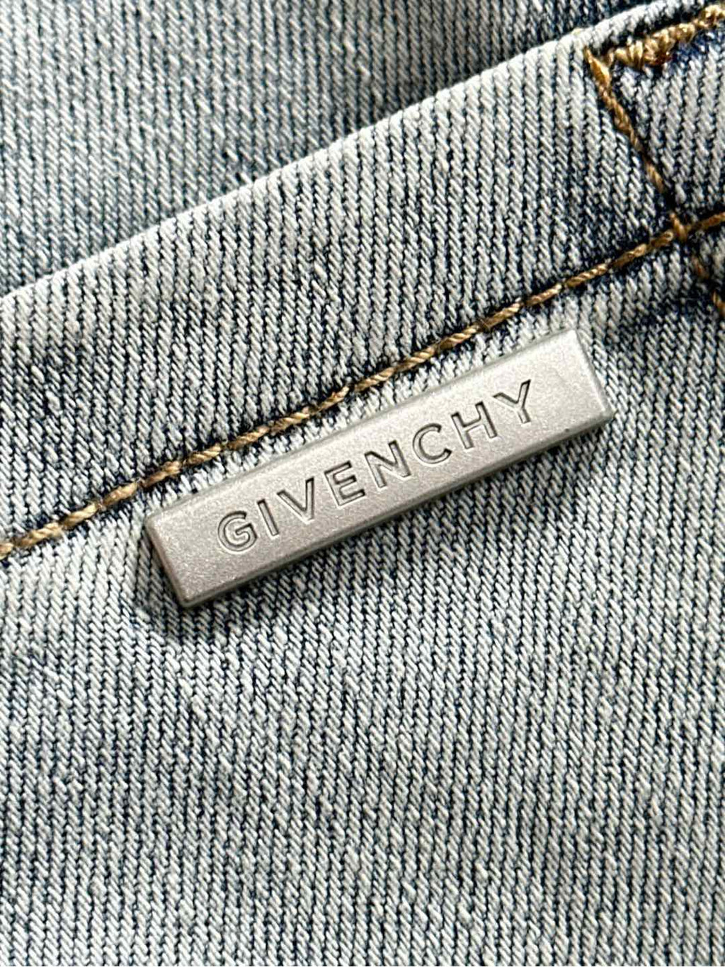 Givenchy denim fabric label, close-up with brand text