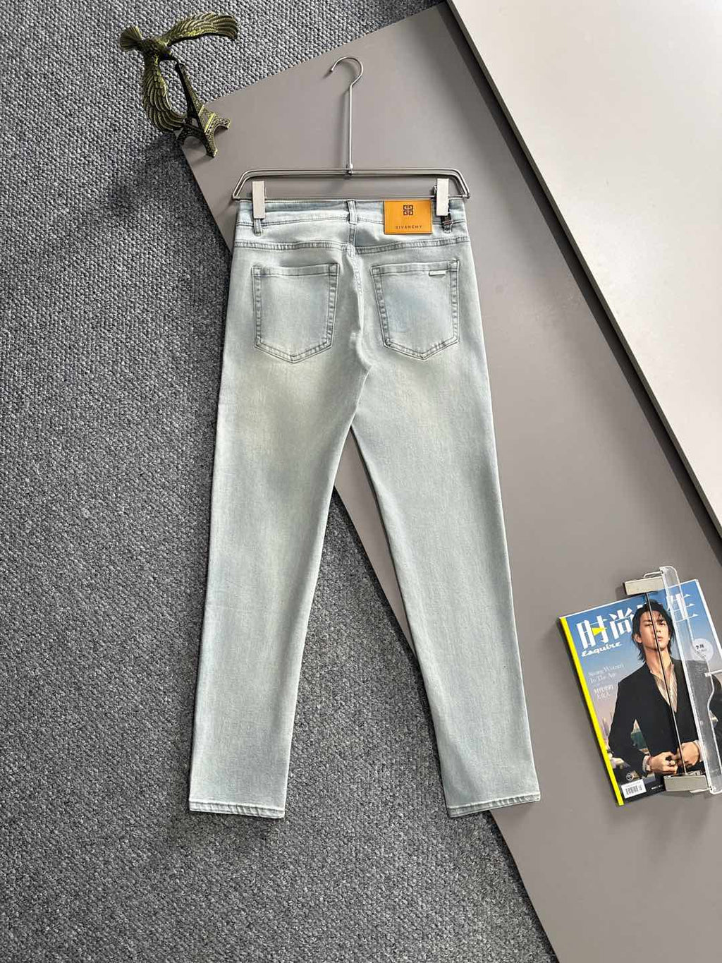 Givenchy light-wash jeans on hanger, front view