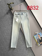 Light-wash Dior denim pants on hanger, five-pocket style with belt loops