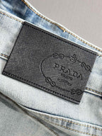 Denim pants with embossed brand label at waistband and visible stitching