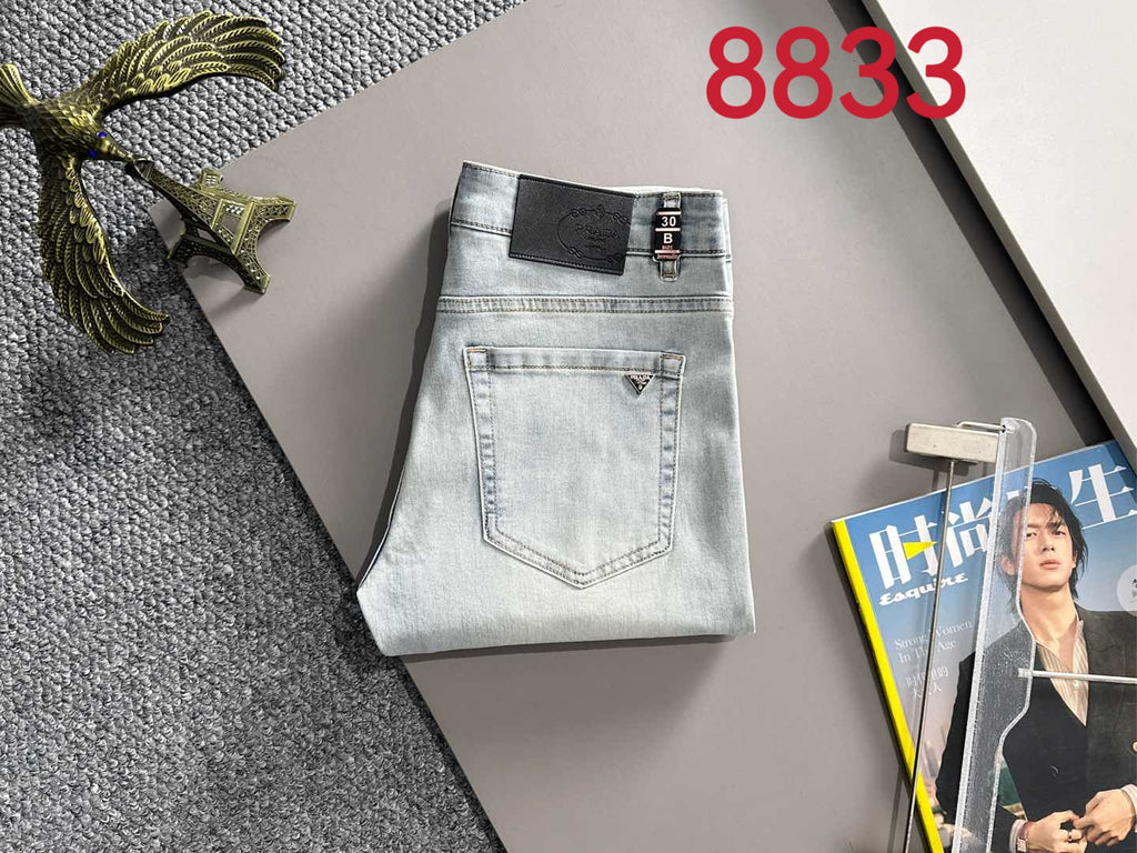 Light blue denim pants folded flat with front pockets and waistband logo patch