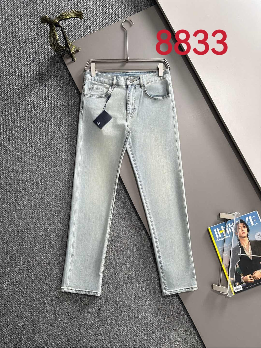 Light blue denim pants with belt loops and front button-and-zip closure
