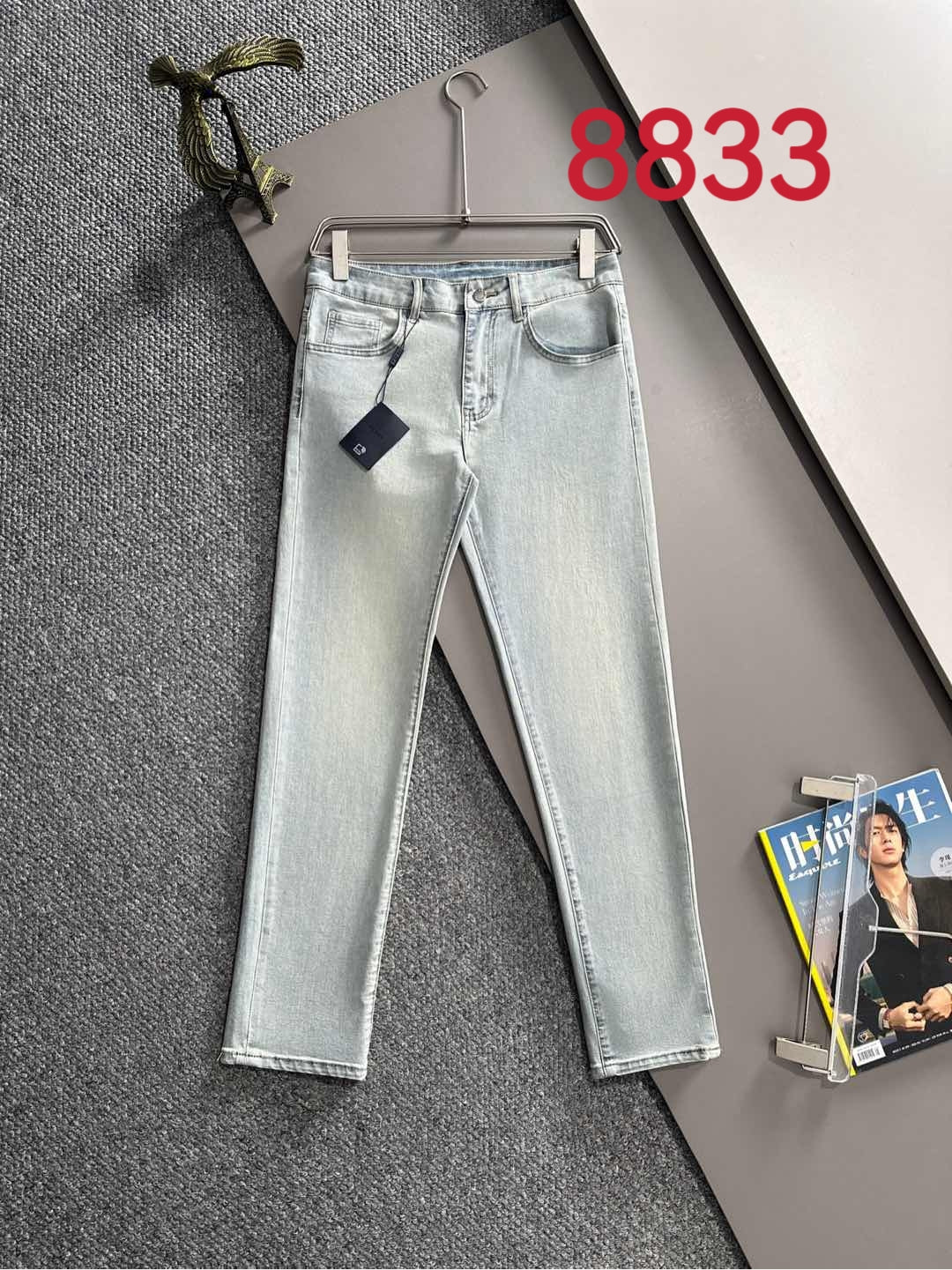 Light blue denim pants with belt loops and front button-and-zip closure