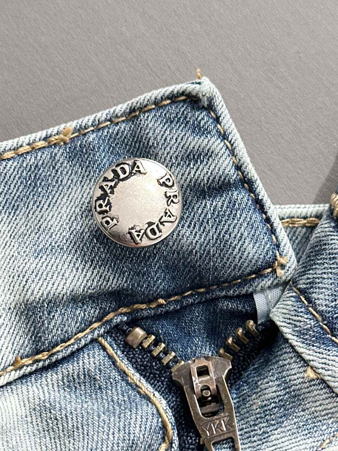 Denim pants coin pocket with round Prada logo patch and metal button
