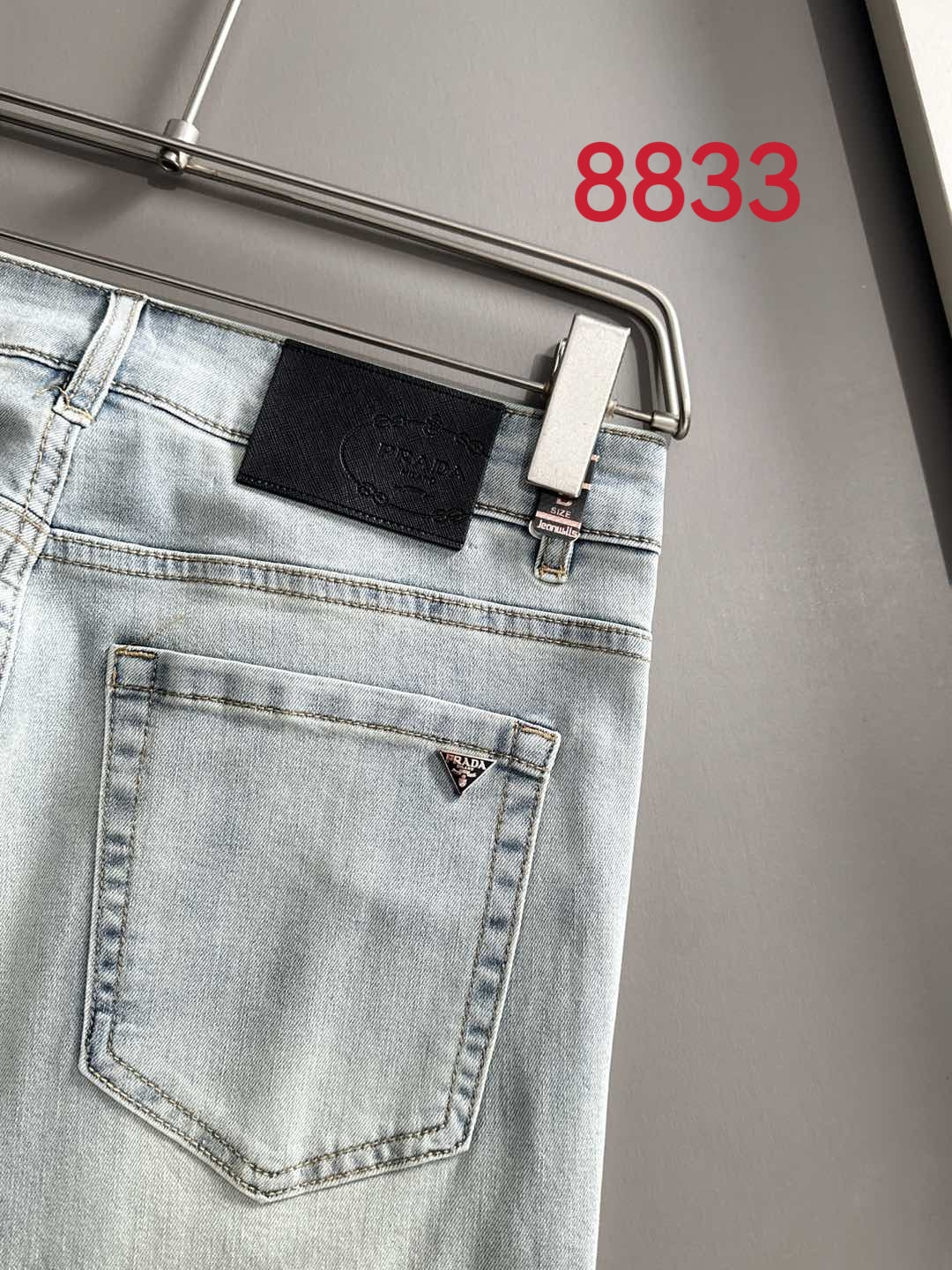 Light blue denim pants front view with back pocket and belt loops