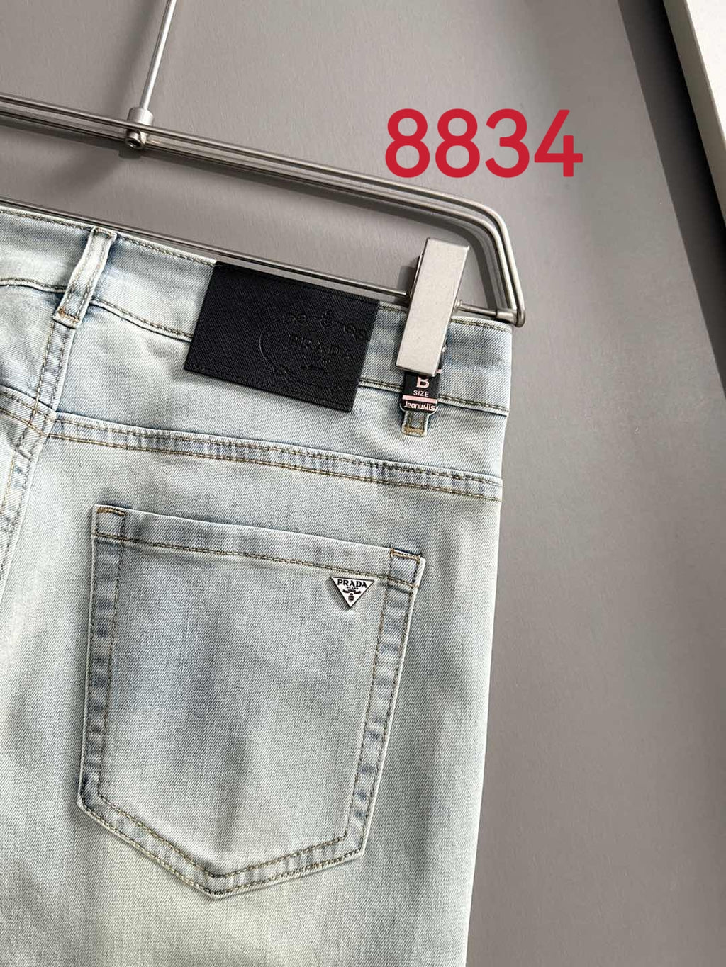 Prada light-wash denim pants with a front patch pocket and belt loops