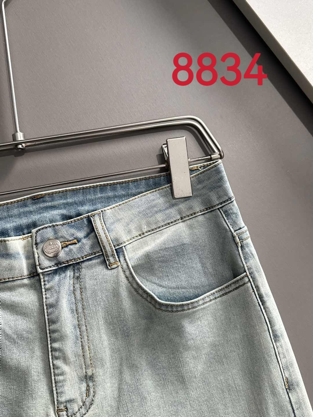 Prada light-wash denim pants with waistband tab and button closure