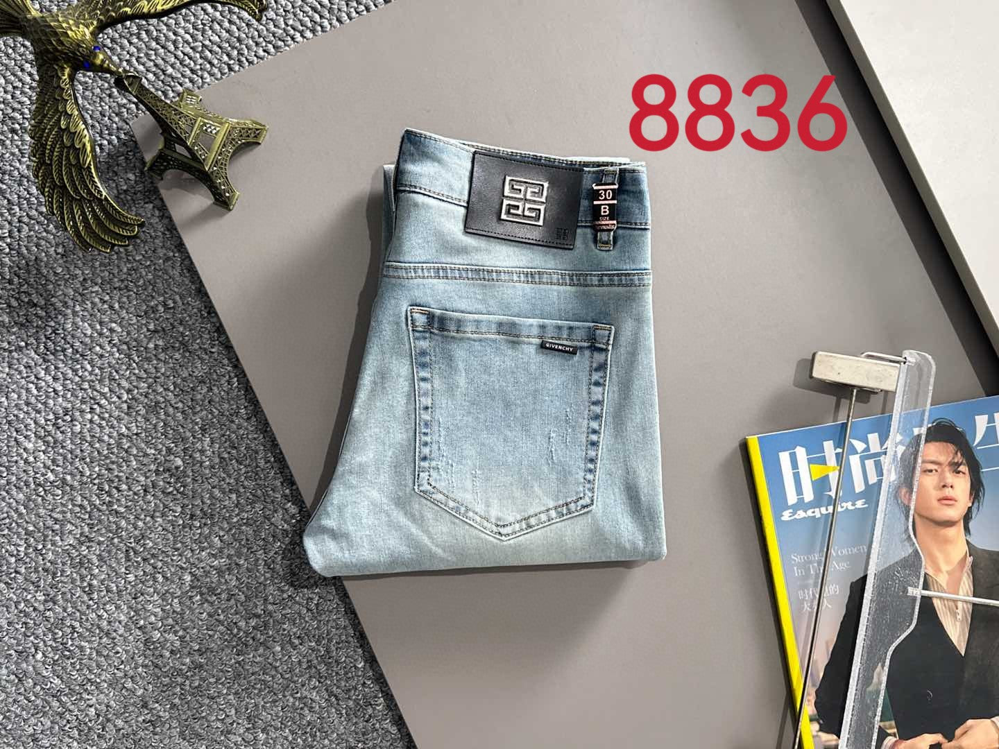 Givenchy light-wash denim jeans on hanger with front pocket details