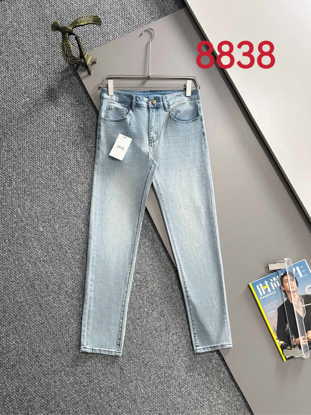 Light blue denim pants with belt loops, zipper fly, and size tag