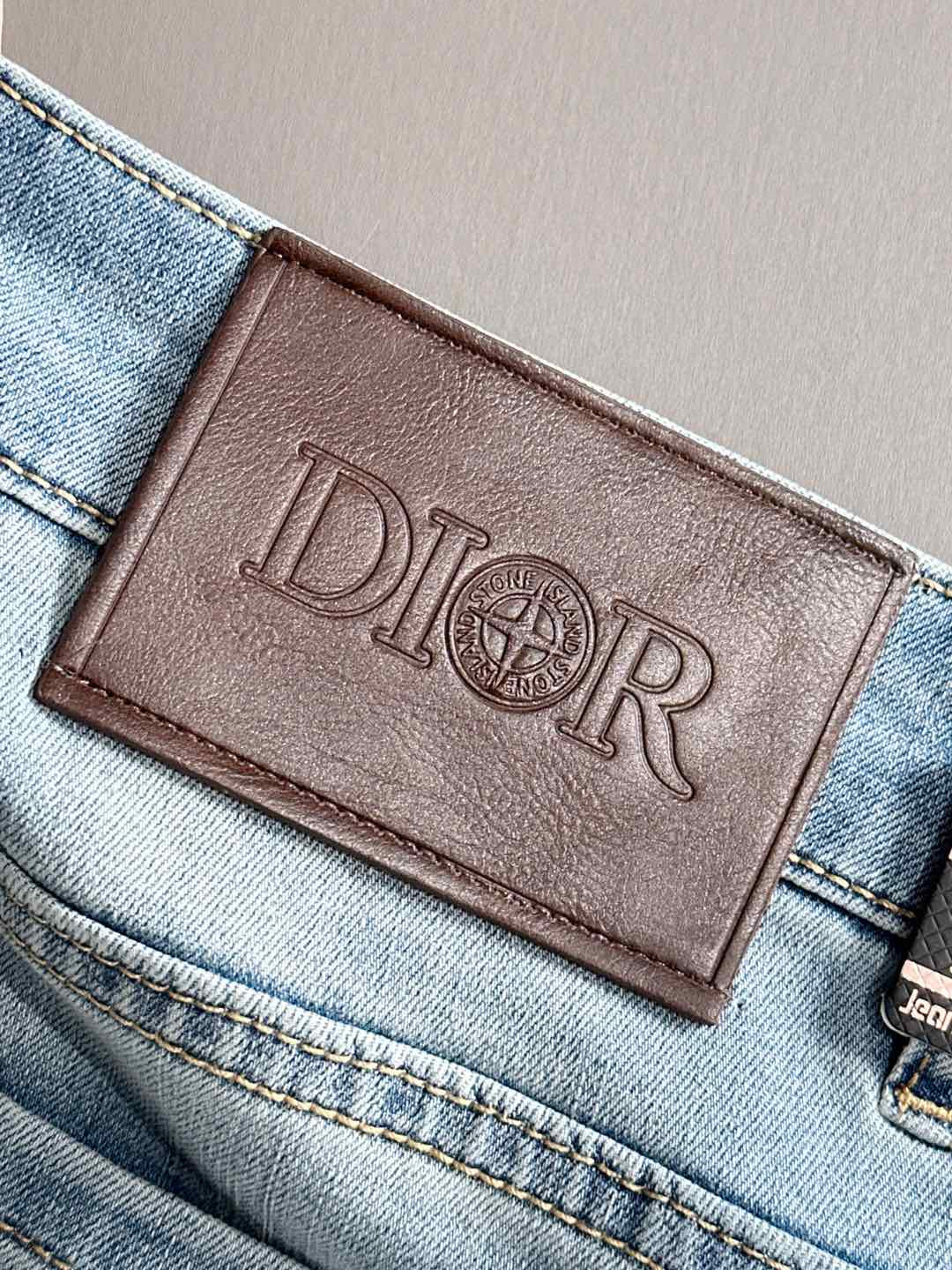 Brown leather Dior logo patch on light blue denim waistband