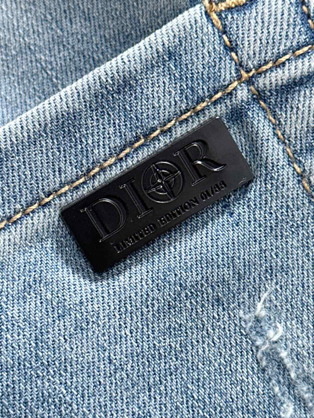 Black Dior leather logo label stitched on light blue denim waistband