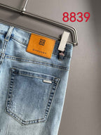 Light blue denim back pocket with orange GIVENCHY patch on the waistband.