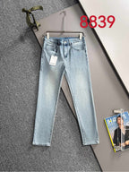 Light blue denim jeans on a hanger, showing front pockets and a side tag.
