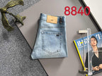 Louis Vuitton light blue denim jeans folded with tan logo patch