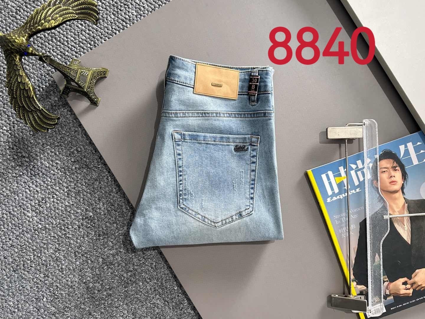 Louis Vuitton light blue denim jeans folded with tan logo patch