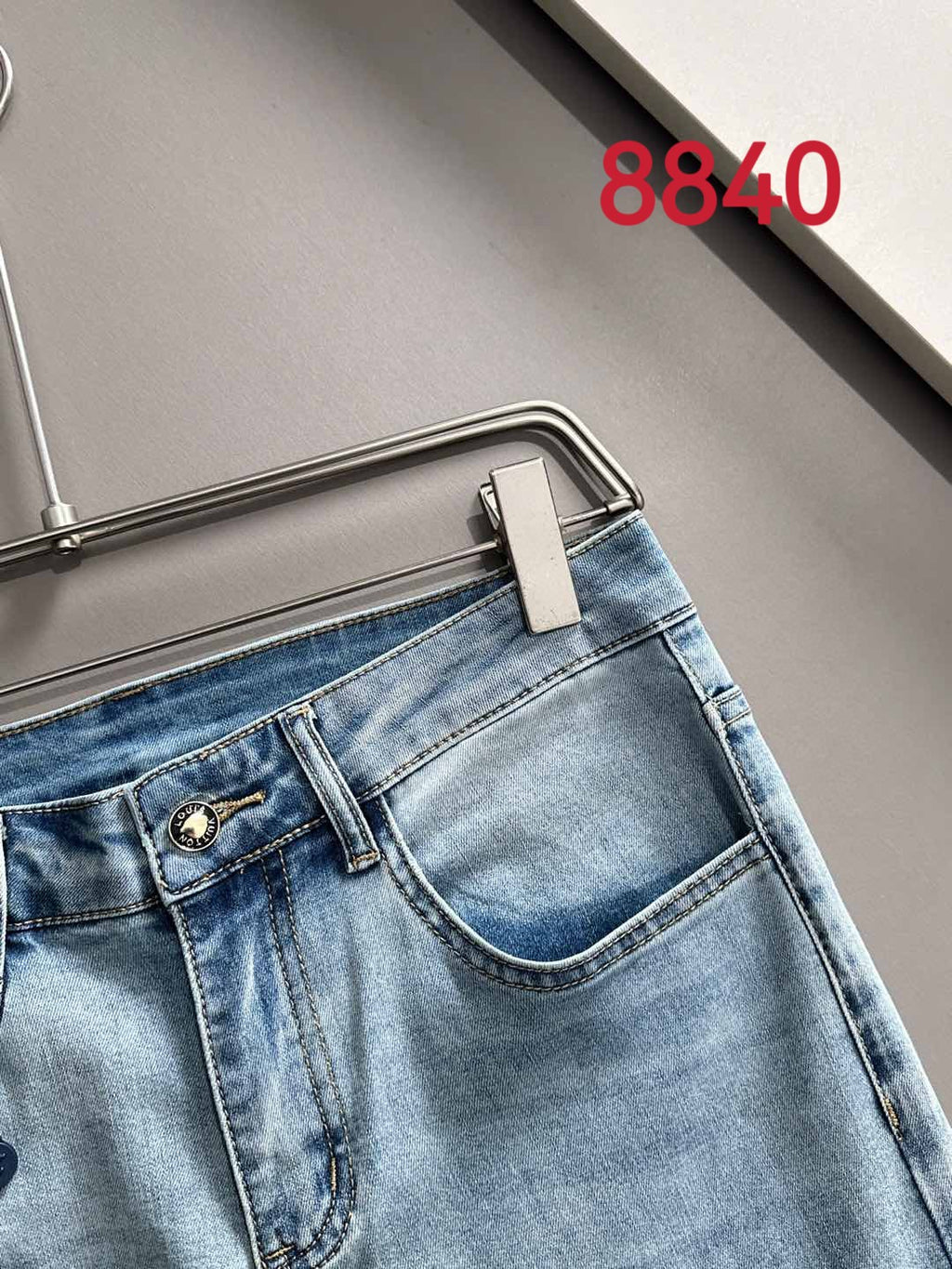 Louis Vuitton light blue denim jeans with metal button and waistband detail