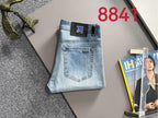 Light blue denim jeans laid flat, showing front pocket and button closure.
