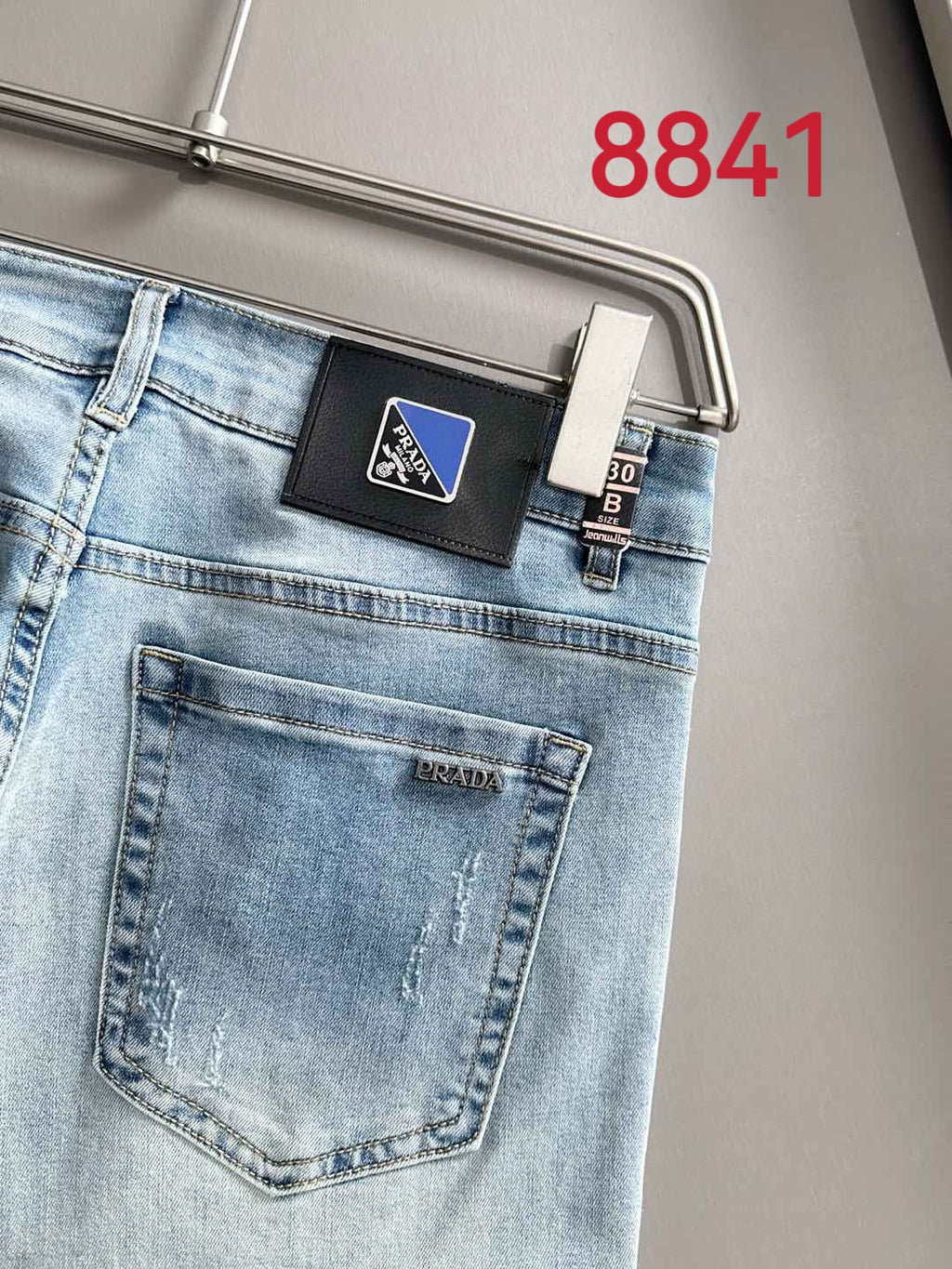 Light blue denim jeans logo label and back pocket close-up.