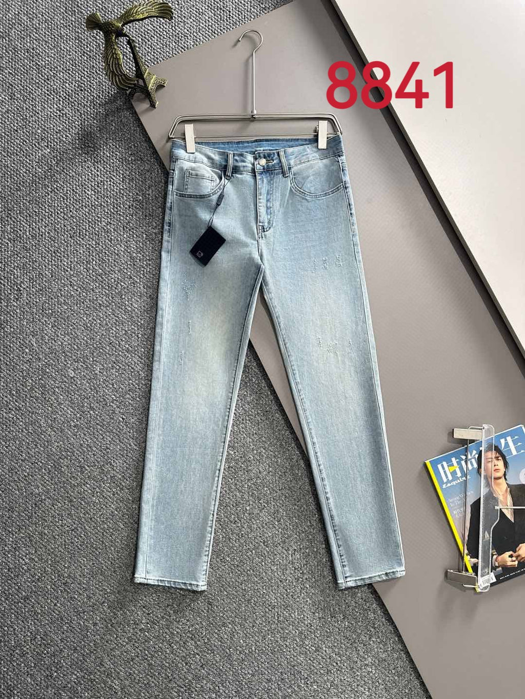 Light blue denim jeans, back view with waistband patch and straight legs.