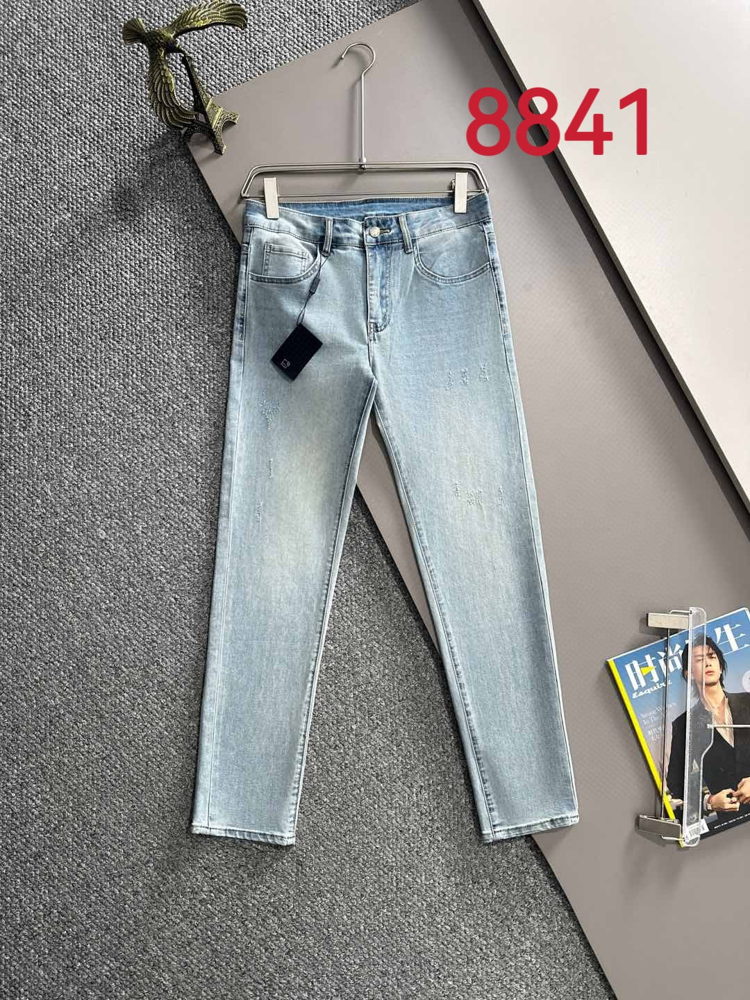 Light blue denim jeans, back view with waistband patch and straight legs.