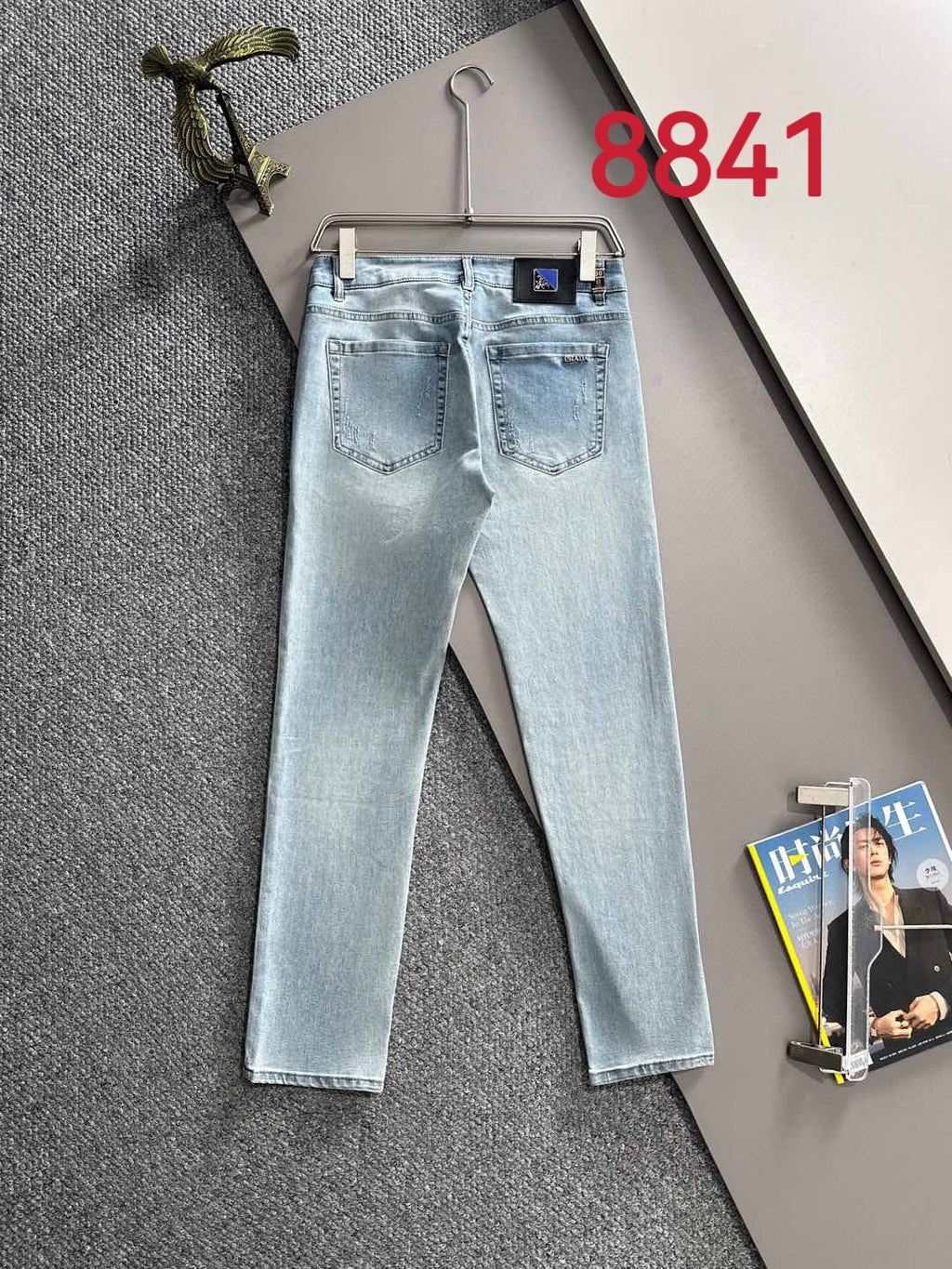 Light blue denim jeans, front view with belt loops and straight legs.