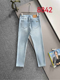 Light blue denim jeans with belt loops and front pockets on hanger