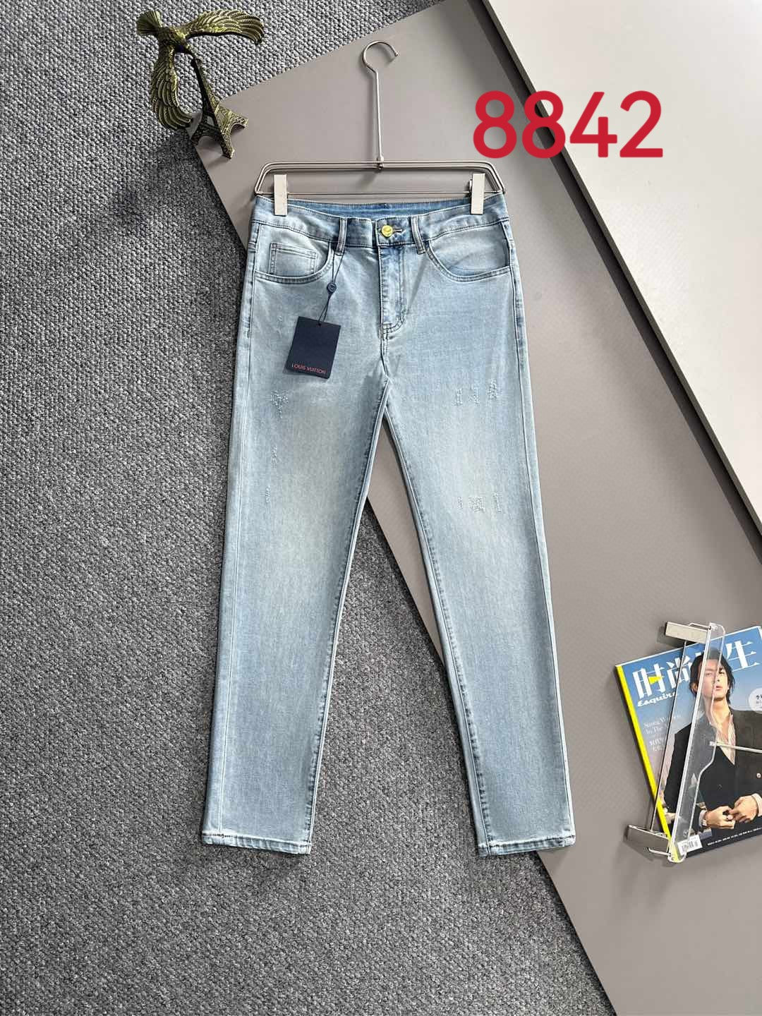 Light blue denim jeans with belt loops and front pockets, straight leg fit