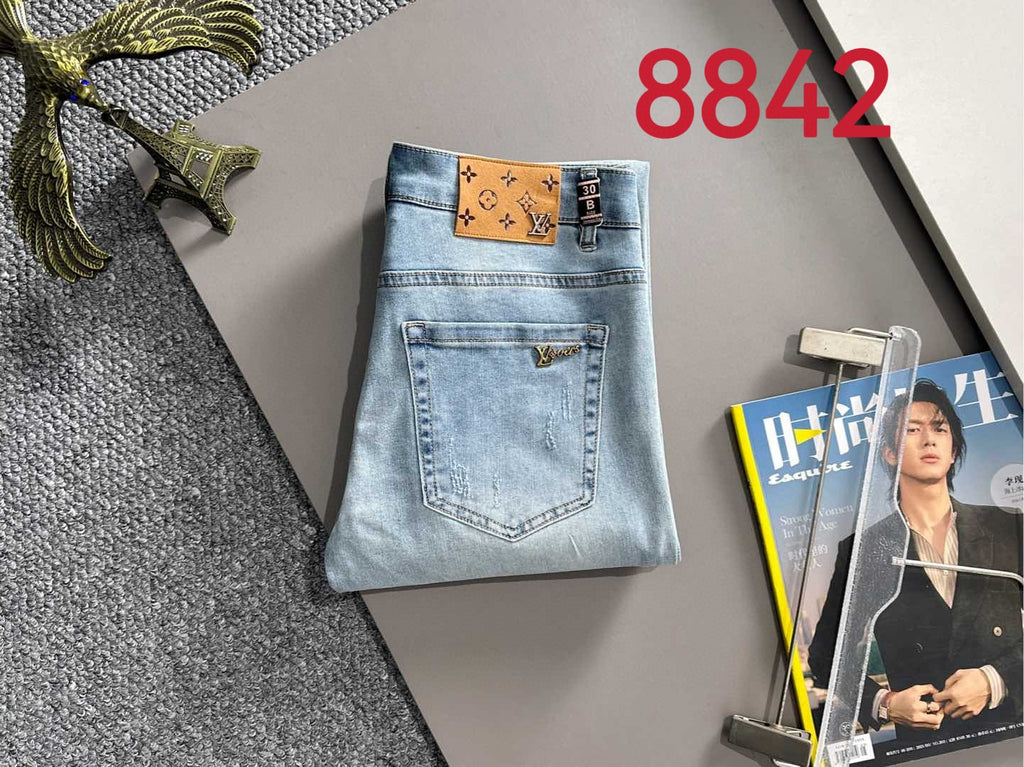 Light blue denim jeans with brown logo waistband patch and back pocket
