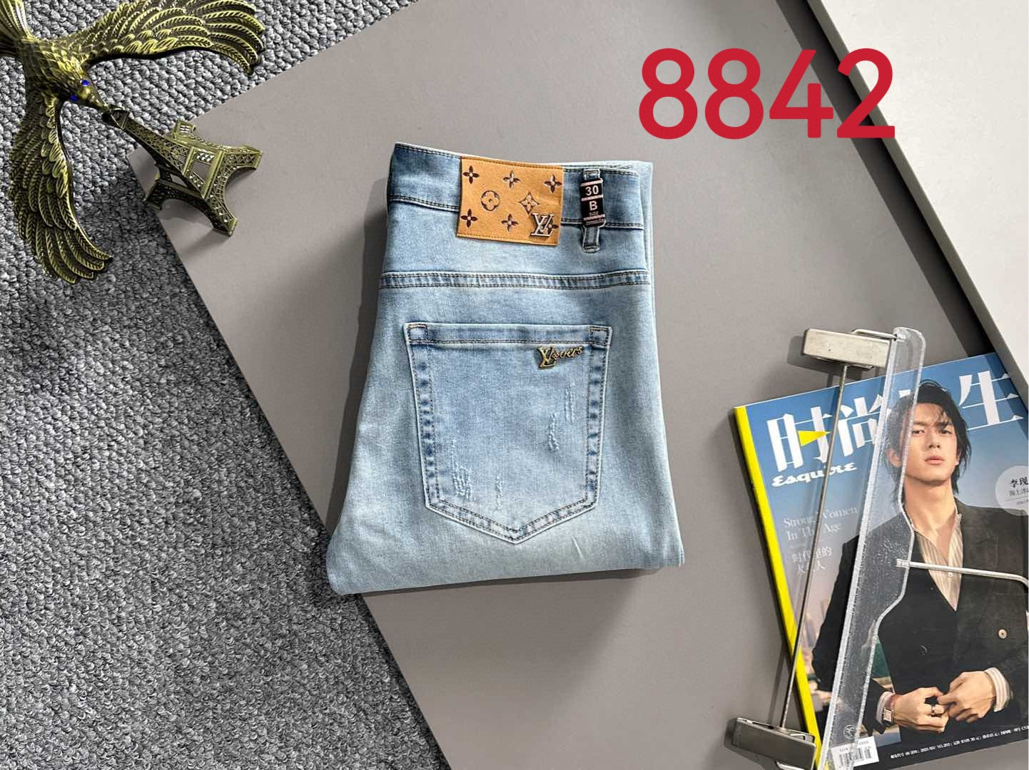 Light blue denim jeans with brown logo waistband patch and back pocket