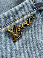 Gold Louis Vuitton logo on light blue denim fabric