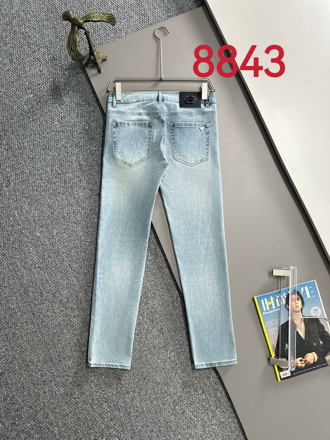 Light blue denim pants with straight legs, five-pocket design and belt loops.